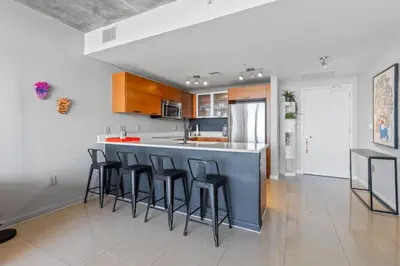 a kitchen with a island with bar stools at Quiet & central Apt in Midtown Miami in Miami