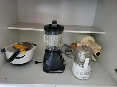 a blender sitting on a kitchen counter next to a mortar and pestle at Cozy family home in quiet area, nice garden views. in Tamiami