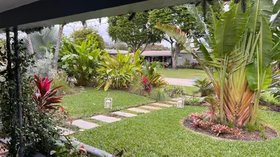 a garden with a walkway in the grass with plants at Paradise Gardens-Wilton Manors- Male only in Fort Lauderdale