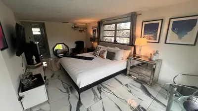 a bedroom with a bed and a television in it at Paradise Gardens-Wilton Manors- Male only in Fort Lauderdale