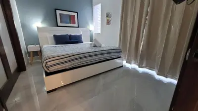 a small bedroom with a bed with blue sheets at Strand Ocean Drive Suites in Miami Beach
