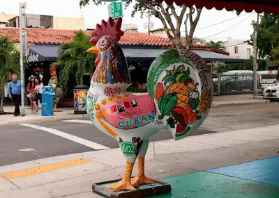 a statue of a chicken sitting on a sidewalk at Apartment in Calle Ocho a Slice of Little Havana in Miami