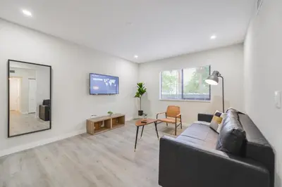 a living room with a couch and a mirror at Apartment in Calle Ocho a Slice of Little Havana in Miami