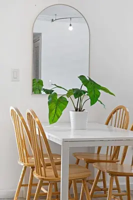 a white table with chairs and a potted plant at Las Olas Blvd Waterfront Apt in Fort Lauderdale