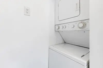 a white laundry room with a washer and dryer at Las Olas Blvd Waterfront Apt in Fort Lauderdale