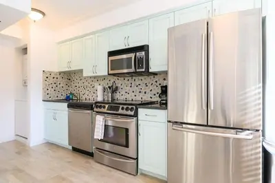 a kitchen with a stainless steel refrigerator and a microwave at Las Olas Blvd Waterfront Apt in Fort Lauderdale