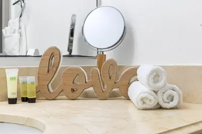 a bathroom with towels and a mirror on a counter at Beach Apt with Waterview in Las Olas Blvd in Fort Lauderdale