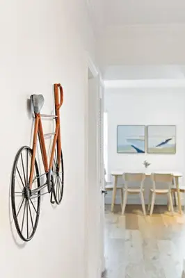 an orange bike hanging on a wall in a room at Beach Apt with Waterview in Las Olas Blvd in Fort Lauderdale