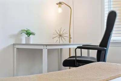 a desk with a black chair and a lamp at Beach Apt with Waterview in Las Olas Blvd in Fort Lauderdale