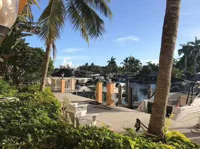 a marina with chairs and palm trees and a harbor at Beach Apt with Waterview in Las Olas Blvd in Fort Lauderdale