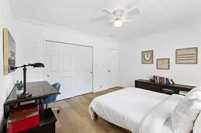 a white bedroom with a bed and a ceiling fan at Spacious Beach Apt in Las Olas Blvd in Fort Lauderdale