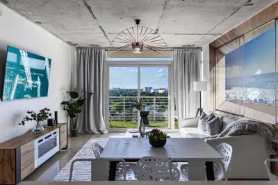 a living room with a table and a large window at Coco Loco - Wynwood in Miami