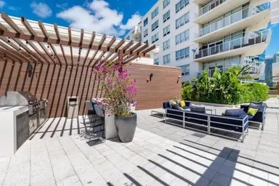 a patio with a wooden pergola and a bench at Coco Loco - Wynwood in Miami