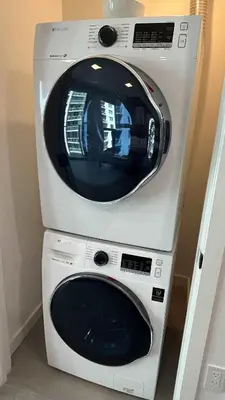 a washing machine sitting on top of a dryer at Huge Studio POOL & GYM - Explore Miami's Heat in Miami