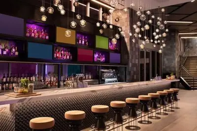 a bar with a row of stools in a restaurant at Huge Studio POOL & GYM - Explore Miami's Heat in Miami