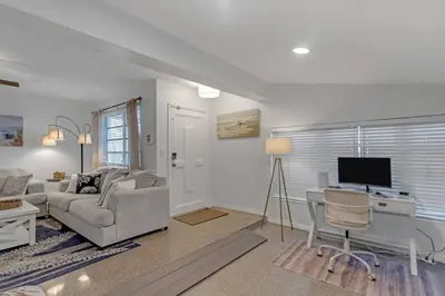 a living room with a couch and a desk with a television at 7-Person Luxury Spa, Fenced Paradise, Beach Vibes in Pembroke Pines
