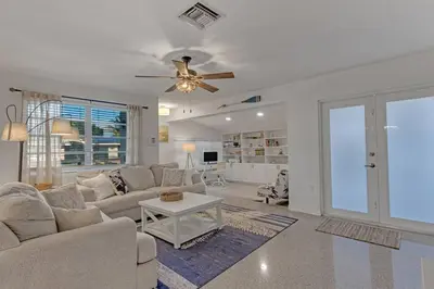 a living room with a couch and a ceiling fan at 7-Person Luxury Spa, Fenced Paradise, Beach Vibes in Pembroke Pines