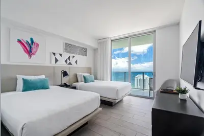 a hotel room with two beds and a large window at Oceanview 2BR and luxury amenities at Hyde Beach House in Hollywood
