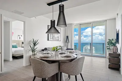 a dining room and living room with a table and chairs at Oceanview 2BR and luxury amenities at Hyde Beach House in Hollywood