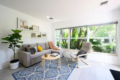 a living room with a couch and a table at Bright & Comfortable Apt in Victoria Park in Fort Lauderdale
