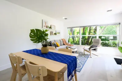 a living room with a table and chairs and a couch at Bright & Comfortable Apt in Victoria Park in Fort Lauderdale
