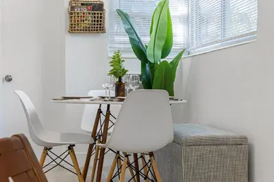 a dining room with a table and a potted plant at Lake Ridge Villa in Fort Lauderdale