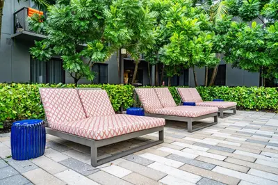 a row of chairs sitting on a patio at Amazing 2 Bedroom Unit In Doral Miami With Free Parking in Hialeah Gardens