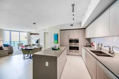 an open kitchen and living room with a view of a living room at Ocean & City Views l Luxury Beachfront Condo in Hollywood