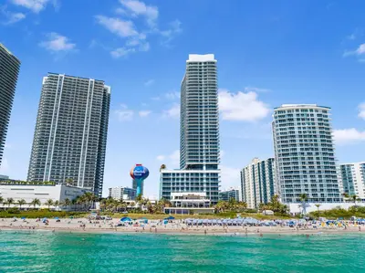 a beach in front of a city with tall buildings at Ocean & City Views l Luxury Beachfront Condo in Hollywood