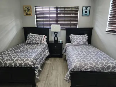 a bedroom with two beds next to a window at The Perfect Vacation Getaway ! in Miami