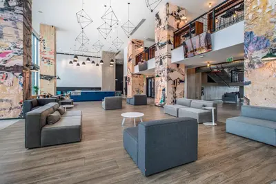 a lobby with couches and chairs and a table at Sentral Alea Miami in Miami
