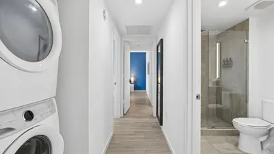 a bathroom with a washing machine and a toilet at Sentral Alea Miami in Miami