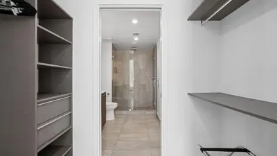 a bathroom with a toilet and a walk in closet at Sentral Alea Miami in Miami