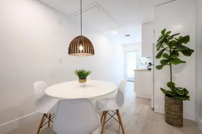 a white dining room with a white table and chairs at Beautiful And Comfortable Apt in Victoria Park in Fort Lauderdale