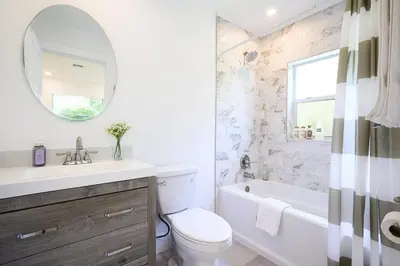 a bathroom with a sink toilet and a tub and a mirror at Beautiful And Comfortable Apt in Victoria Park in Fort Lauderdale