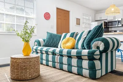 a green and white couch in a living room at Lovely 2 BR condo in Sailboat Bend in Fort Lauderdale
