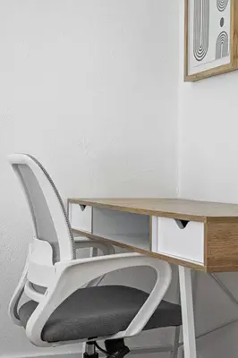 a white desk with a white chair next to a table at Musicians Lounge - 2 BR with parking asssigned in Fort Lauderdale
