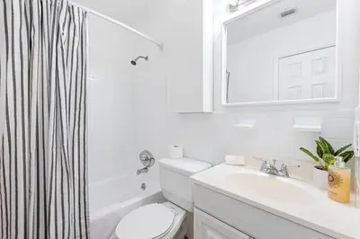 a bathroom with a sink and a toilet and a mirror at Musicians Lounge - 2 BR with parking asssigned in Fort Lauderdale
