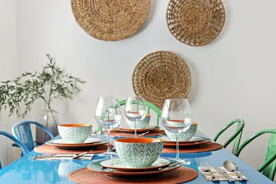 a table with wine glasses and plates on it at Stylish 2 BR condo - close to Riverwalk in Fort Lauderdale