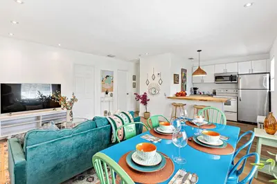 a living room with a blue couch and a table at Stylish 2 BR condo - close to Riverwalk in Fort Lauderdale