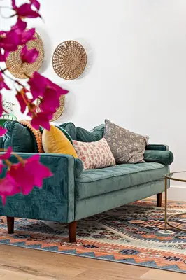 a green couch with pillows on it in a living room at Stylish 2 BR condo - close to Riverwalk in Fort Lauderdale