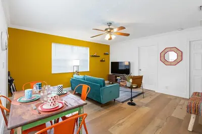 a living room with a table and a blue couch at The Yellow Submarine @Sailboat Bend in Fort Lauderdale