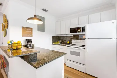 a kitchen with white appliances and a white refrigerator at The Yellow Submarine @Sailboat Bend in Fort Lauderdale