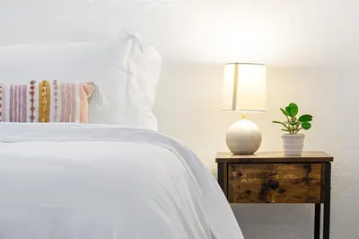 a bedroom with a bed with a lamp on a night stand at The Yellow Submarine @Sailboat Bend in Fort Lauderdale