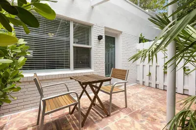 a wooden table and chairs on a patio at Victoria Park Unique Studio close to Las Olas Blvd in Fort Lauderdale