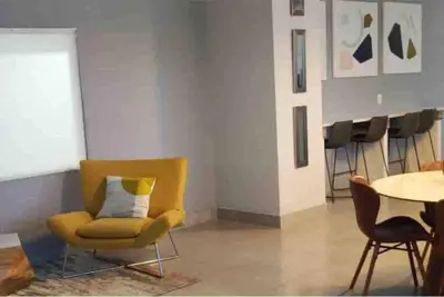 a living room with a yellow chair and a table at Club at Brickell Bay Bayview Balcony 1BR Free Parking in Miami
