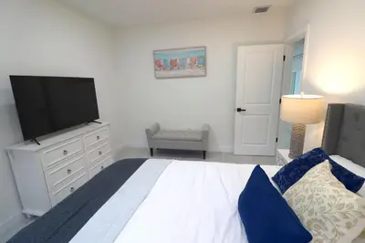 a bedroom with a bed and a flat screen tv at Villa Cristina in Miami in Miami