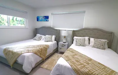 a bedroom with two beds and a window at Villa Cristina in Miami in Miami
