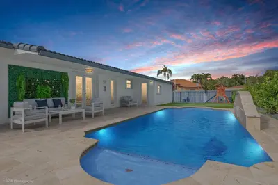 a swimming pool in the backyard of a house at Le Femme Paradise -Htd Pool, Mini Golf, 5 Bedrooms, Jacuzzi, Game Room, BBQ,Pickleball in Miami