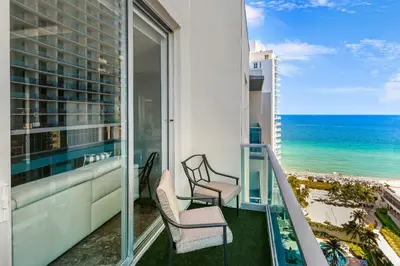 a balcony with two chairs and a view of the ocean at LUXURY PENTHOUSE ON THE BEACH 3/3 OCEANFRONT CONDO in Hollywood